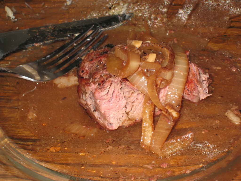 Chuck roast drizzled with Au Jus and topped with onions